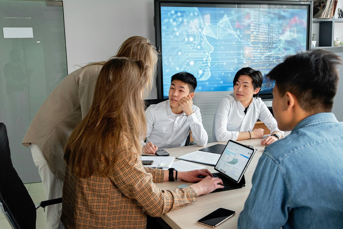 Professionals comparing AI analysis and operational dashboards in a meeting room